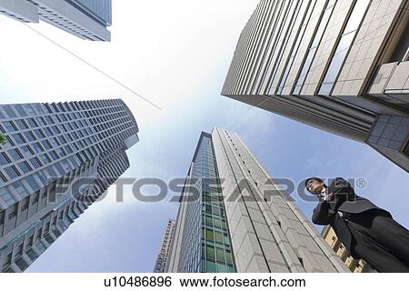 Stock Photograph - A businessman in business district. Fotosearch