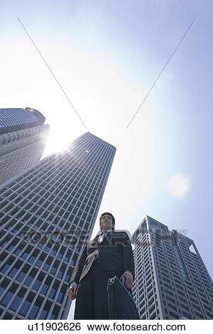 Stock Photograph - A businessman in business district. Fotosearch