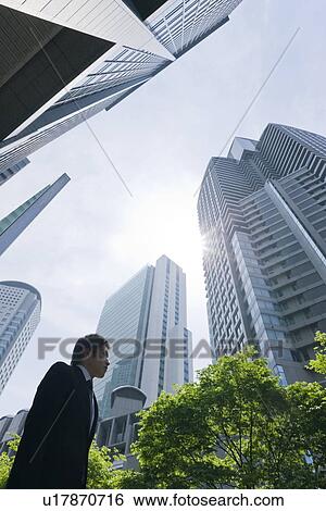Stock Photograph - A businessman in business district. Fotosearch