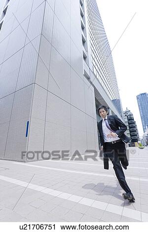 Stock Image - A running businessman. Fotosearch