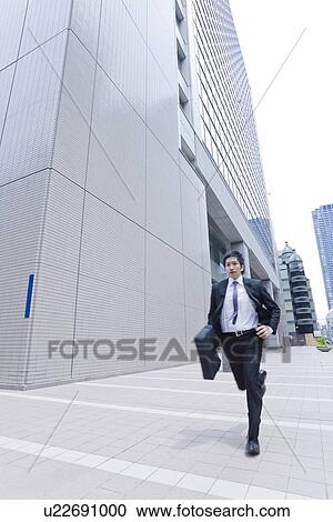 Stock Image - A running businessman. Fotosearch