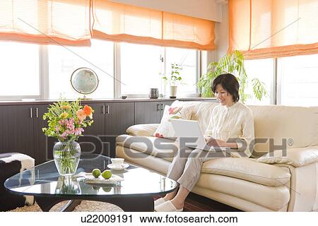 Stock Image - A woman Using PC. Fotosearch