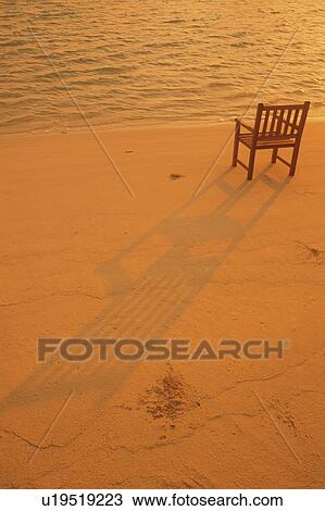 Stock Image - An Armchair Placed on Beach. Fotosearch