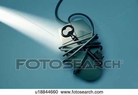 Stock Image - Antique key on computer mouse. Fotosearch