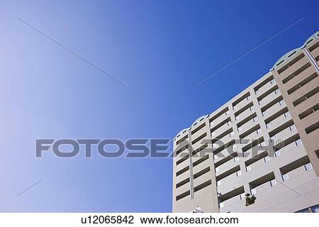 Stock Image - Apartment building under sky, copy space, Nishinomiya city, Hyogo prefecture, Japan. Fotosearch