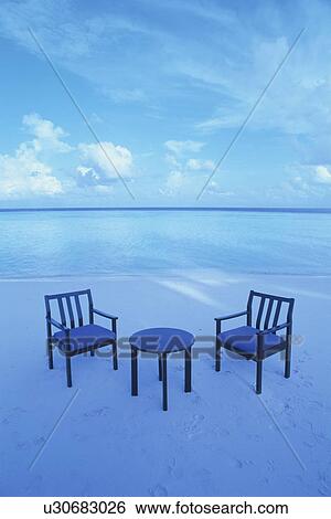 Stock Photograph - Armchairs and Table on Beach. Fotosearch