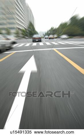 Stock Photography - Arrow sign on road in city, blurred motion, Tokyo prefecture, Kanagawa prefecture, Japan. Fotosearch