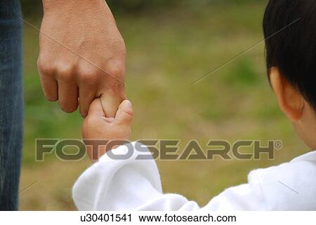Baby boy holding mother's finger, close up View Large Photo Image Stock Image - Baby boy holding mother's finger, close up. Fotosearch