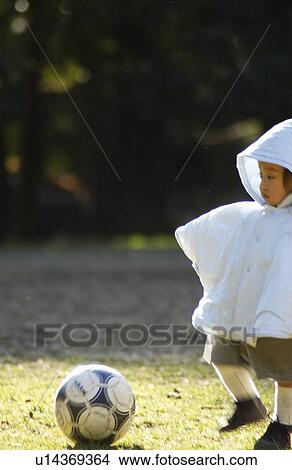 Picture - Baby boy playing soccer, Tokyo Prefecture, Honshu, Japan. Fotosearch