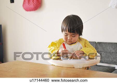 Baby boy sitting in high chair, eating baby food View Large Photo Image Stock Image - Baby boy sitting in high chair, eating baby food. Fotosearch