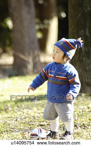 Baby boy with knit hat and football, Tokyo Prefecture, Honshu, Japan View Large Photo Image Picture - Baby boy with knit hat and football, Tokyo Prefecture, Honshu, Japan. Fotosearch