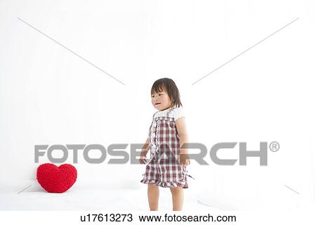 Baby girl and heart shaped cushion View Large Photo Image Stock Image - Baby girl and heart shaped cushion. Fotosearch