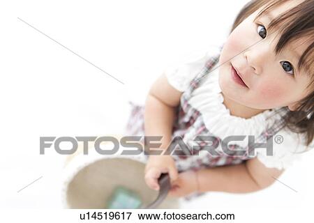 Stock Photo - Baby girl holding a basket. Fotosearch