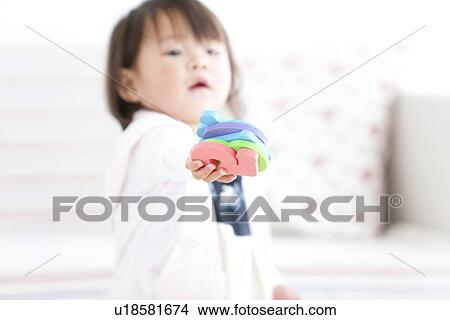Baby girl holding alphabet and number toys View Large Photo Image Picture - Baby girl holding alphabet and number toys. Fotosearch