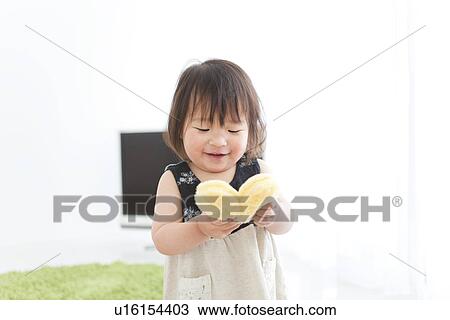 Baby girl holding heart shaped cushion View Large Photo Image Stock Image - Baby girl holding heart shaped cushion. Fotosearch