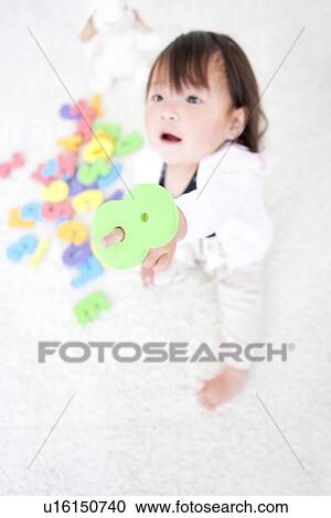Baby girl holding number toy View Large Photo Image Stock Image - Baby girl holding number toy. Fotosearch