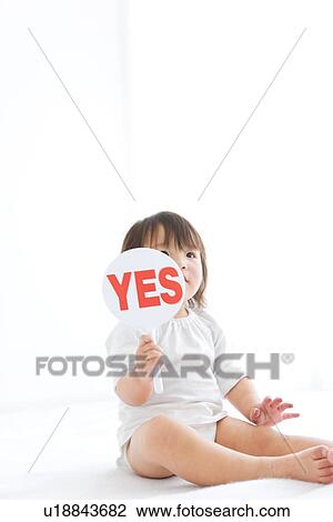 Baby girl holding yes sign View Large Photo Image Stock Image - Baby girl holding yes sign. Fotosearch
