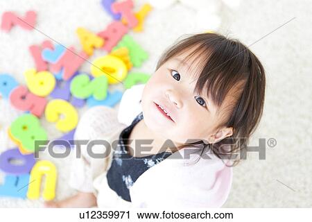 Baby girl looking at camera View Large Photo Image Stock Image - Baby girl looking at camera. Fotosearch