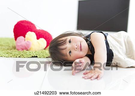 Stock Image - Baby girl lying on side. Fotosearch
