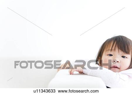 Baby girl next to sofa View Large Photo Image Stock Image - Baby girl next to sofa. Fotosearch