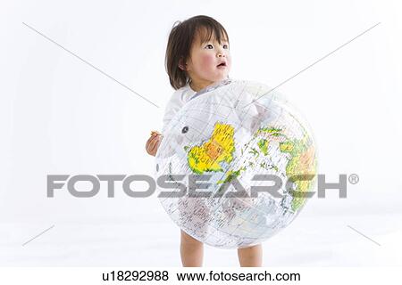 Stock Photo - Baby girl playing with globe beach ball. Fotosearch