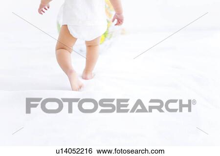 Stock Photograph - Baby girl playing with globe beach ball. Fotosearch
