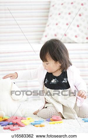 Baby girl playing with toys View Large Photo Image Stock Image - Baby girl playing with toys. Fotosearch