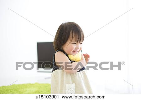 Stock Image - Baby girl standing and smiling. Fotosearch