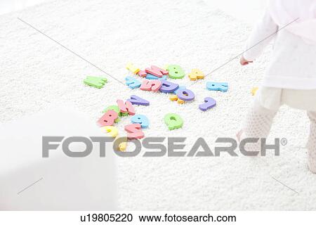 Baby girl standing near alphabet and number toys View Large Photo Image Stock Image - Baby girl standing near alphabet and number toys. Fotosearch