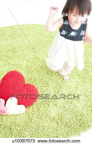 Baby girl standing on rug, high angle view View Large Photo Image Stock Image - Baby girl standing on rug, high angle view. Fotosearch