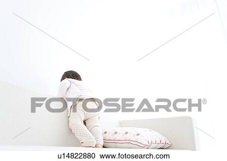 Baby girl standing on sofa View Large Photo Image Stock Image - Baby girl standing on sofa. Fotosearch