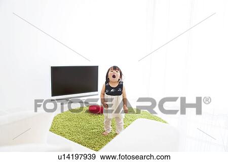 Baby girl standing with mouth open View Large Photo Image Stock Photo - Baby girl standing with mouth open. Fotosearch