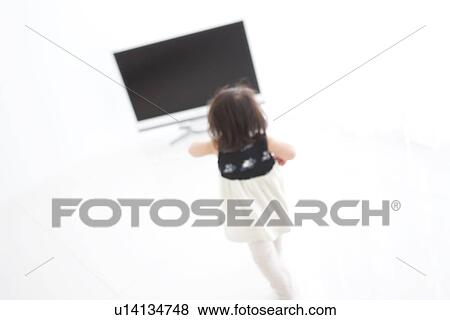 Baby girl walking towards TV View Large Photo Image Stock Photo - Baby girl walking towards TV. Fotosearch