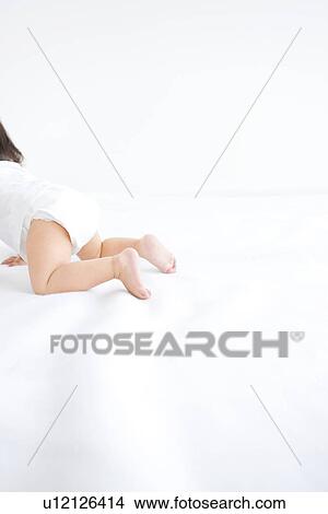 Baby girl wearing diaper and crawling View Large Photo Image Picture - Baby girl wearing diaper and crawling. Fotosearch