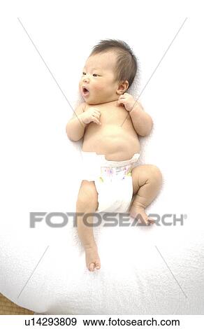 Stock Photo - Baby in diaper on white background. Fotosearch