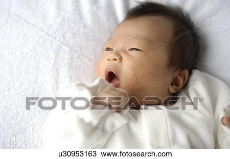 Baby lying on bed, close up View Large Photo Image Stock Image - Baby lying on bed, close up. Fotosearch