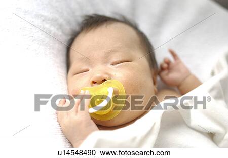 Baby with pacifier sleeping on bed, close up View Large Photo Image Stock Image - Baby with pacifier sleeping on bed, close up. Fotosearch