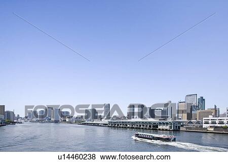 Boat on river and high rise buildings under sky, copy space, Tokyo prefecture, Japan View Large Photo Image Stock Photo - Boat on river and high rise buildings under sky, copy space, Tokyo prefecture, Japan. Fotosearch