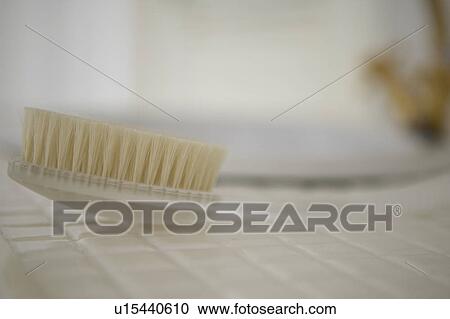 Stock Image - Body brush on floor, close up, differential focus. Fotosearch