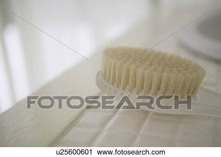 Stock Image - Body brush on floor, close up, differential focus. Fotosearch