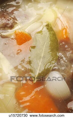 Stock Image - Boiled vegetables with bay leaf, close up, full frame. Fotosearch