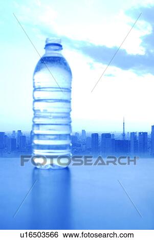 Stock Photograph - Bottle of water, cityscape in background, toned image, Tokyo prefecture, Japan. Fotosearch