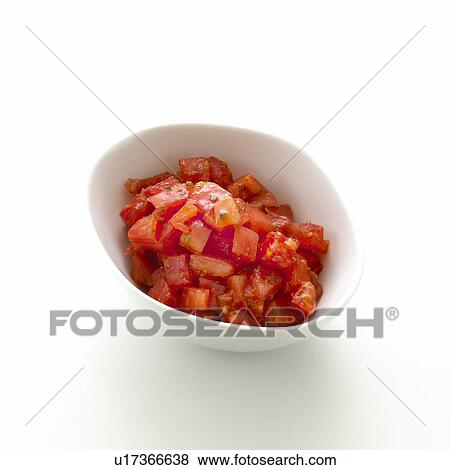 Stock Photo - Bowl of chopped tomato, white background. Fotosearch