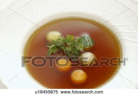 Stock Photography - Bowl of consomme soup, close up. Fotosearch