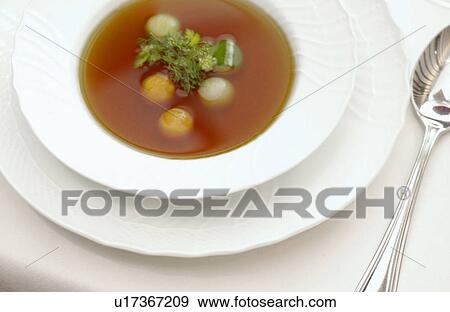 Stock Photo - Bowl of consomme soup, white background. Fotosearch