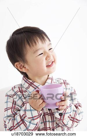 Stock Photo - Boy drinking juice from a plastic cup. Fotosearch