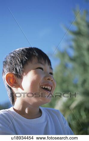 Picture - Boy smiling outdoors. Fotosearch