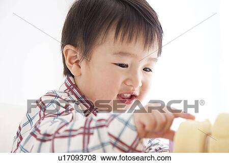 Boy trying to eat a rolled up sponge cake View Large Photo Image Stock Photo - Boy trying to eat a rolled up sponge cake. Fotosearch