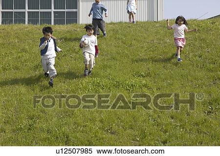 Boys and girls running down the hill View Large Photo Image Stock Photography - Boys and girls running down the hill. Fotosearch