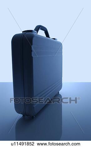 Stock Image - Briefcase, blue background. Fotosearch